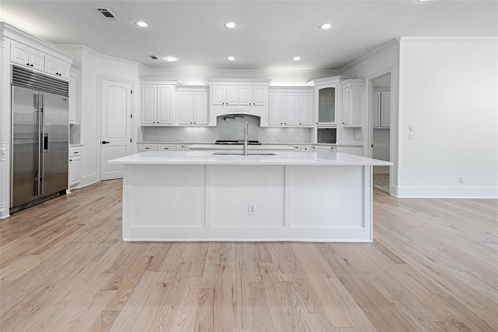 6301 Churchill Way Dallas, TX 75230 - Photo 14 of 40 a large kitchen with stainless steel appliances a large counter top a sink and a refrigerator