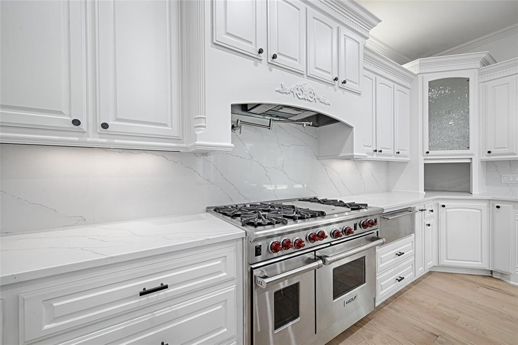 6301 Churchill Way Dallas, TX 75230 - Photo 16 of 40 a kitchen with white cabinets and white appliances