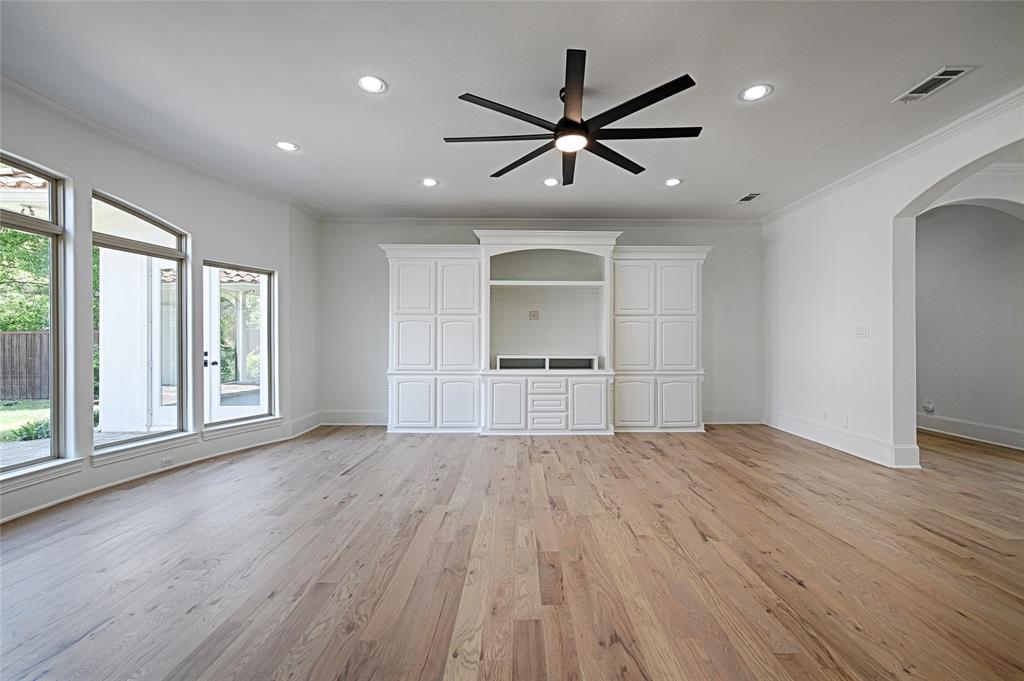 6301 Churchill Way Dallas, TX 75230 - Photo 21 of 40 a view of empty room with wooden floor and window