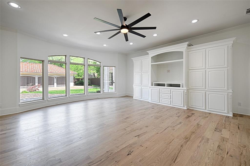 6301 Churchill Way Dallas, TX 75230 - Photo 22 of 40 a view of empty room with wooden floor and ceiling fan