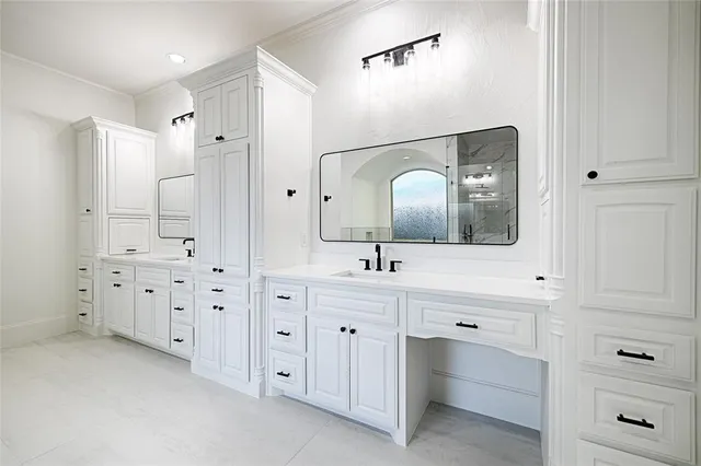 a bathroom with a double vanity sink toilet and shower