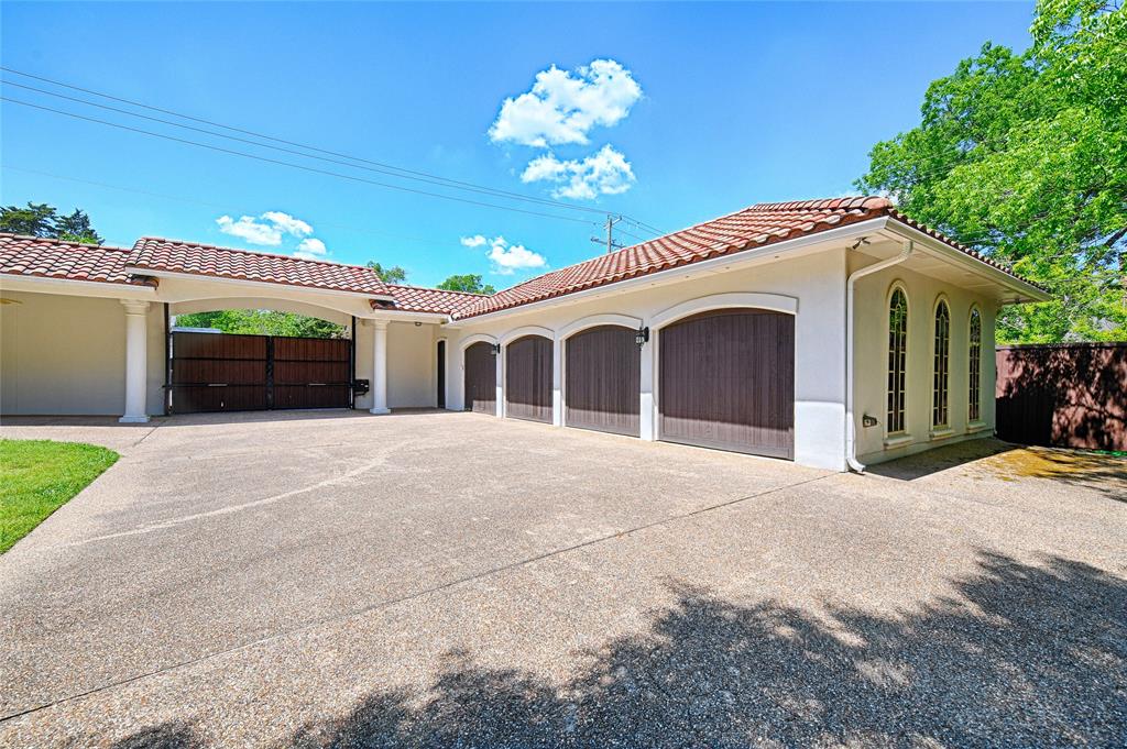 6301 Churchill Way Dallas, TX 75230 - Photo 40 of 40 a front view of a house with a garage