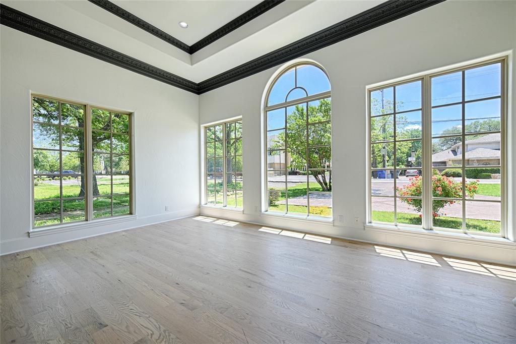 6301 Churchill Way Dallas, TX 75230 - Photo 6 of 40 a view of an empty room with wooden floor and a window