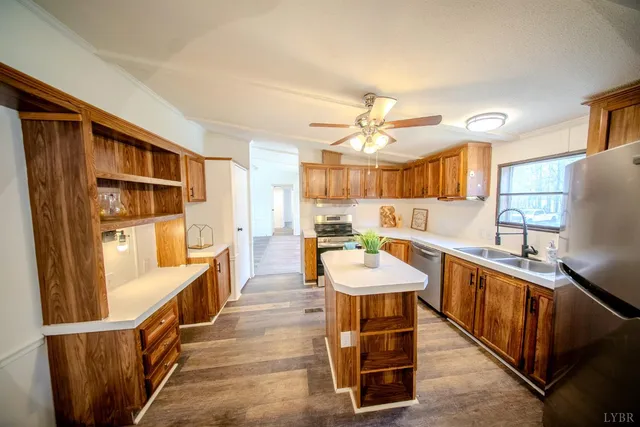 a large white kitchen with a large window and stainless steel appliances