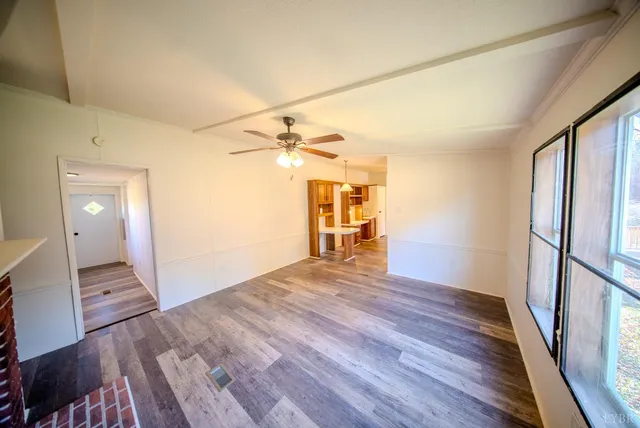 a view of a room with wooden floor and staircase