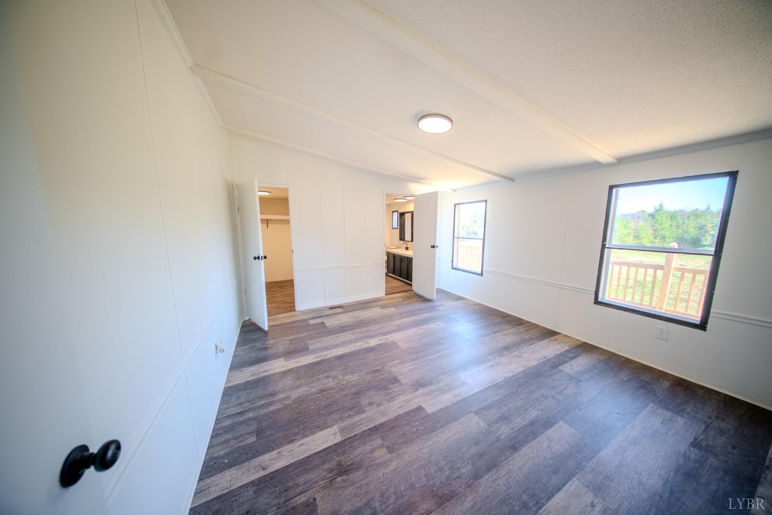 920 Hodnetts Road Gretna, VA 24557 - Photo 14 of 31 an empty room with wooden floor and windows