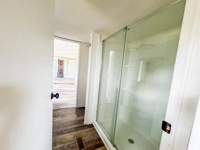 a bathroom with a shower and a sink