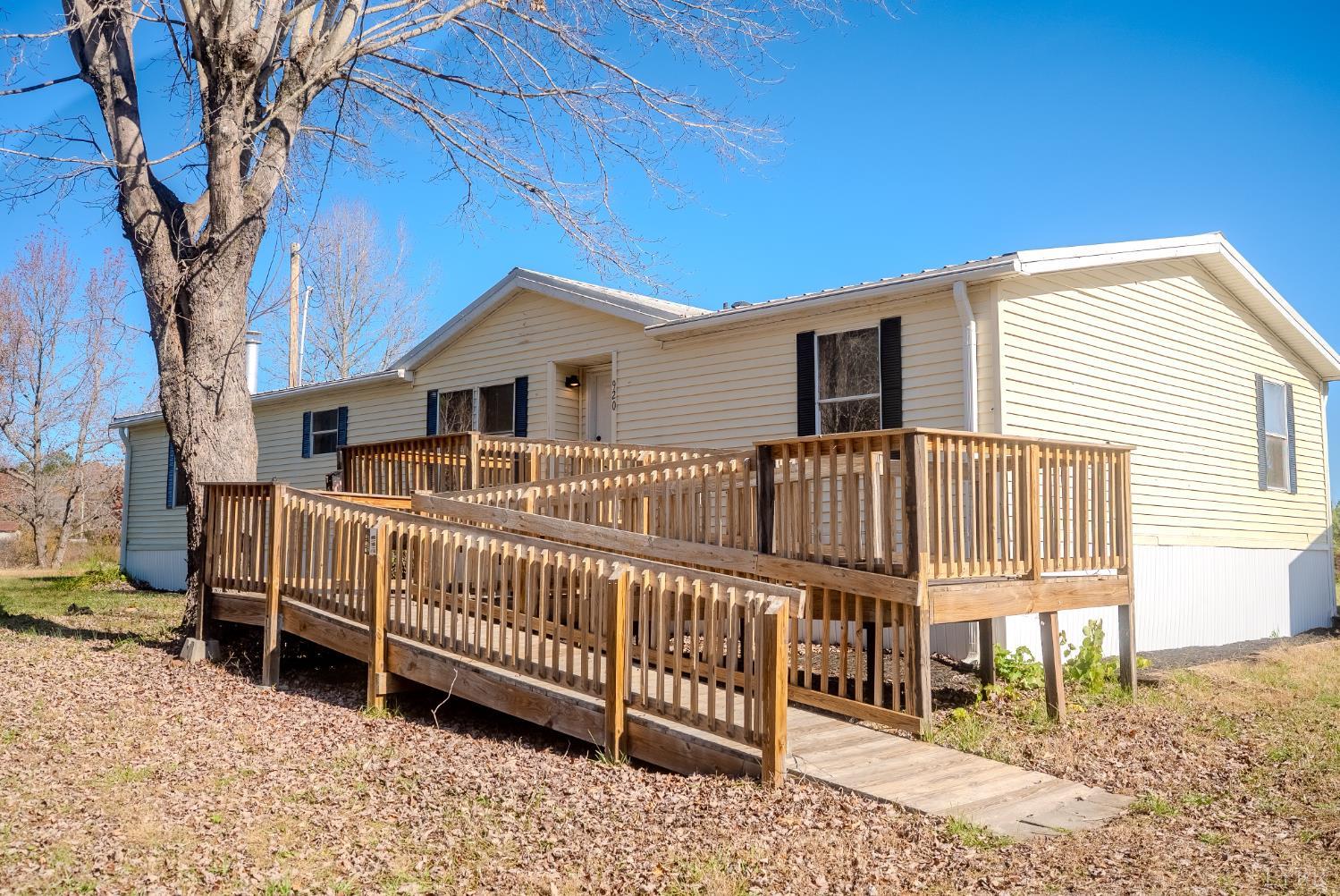 920 Hodnetts Road Gretna, VA 24557 - Photo 26 of 31 a view of a house with a small yard and wooden fence