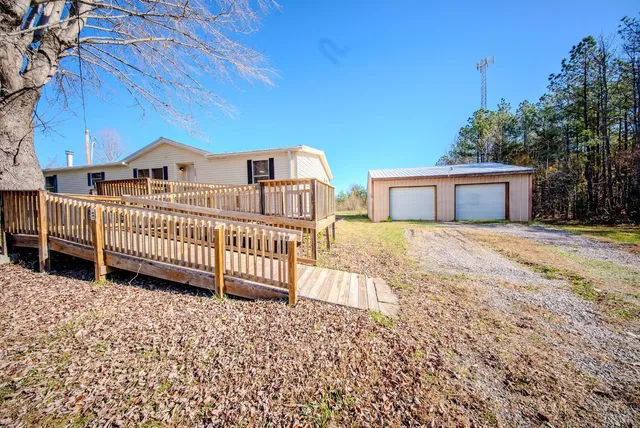 a view of a house with a wooden fence