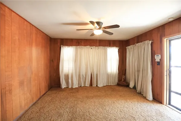 a view of a livingroom with a ceiling fan and window