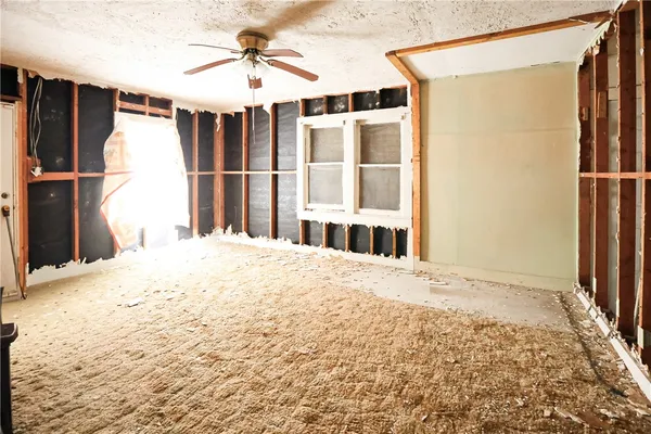 a bedroom with wooden floor and a window