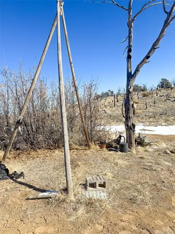 a bed sitting in a bedroom next to a chair