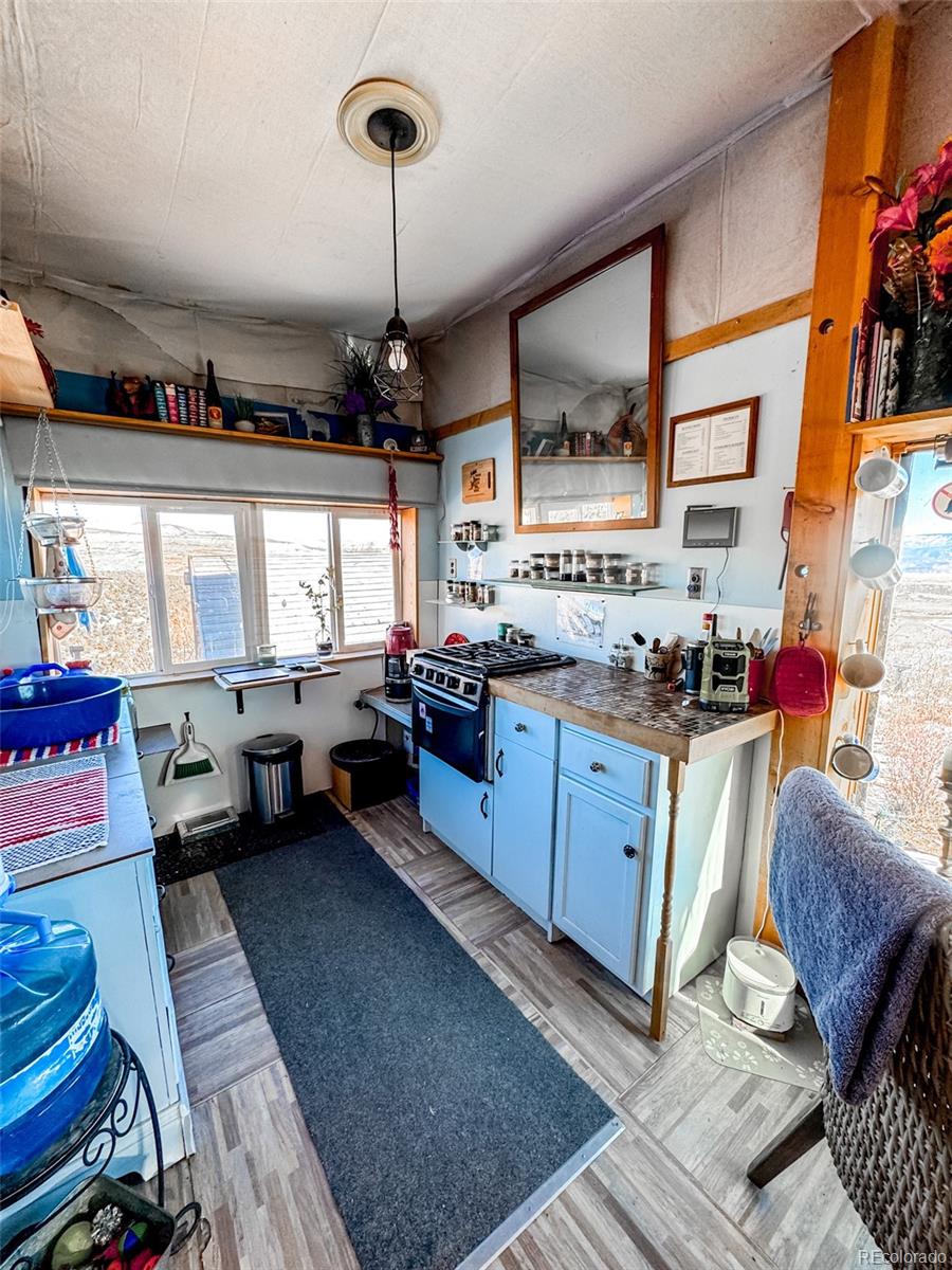 1725 35 1/10 Road De Beque, CO 81630 - Photo 17 of 36 a kitchen with granite countertop lots of counter top space