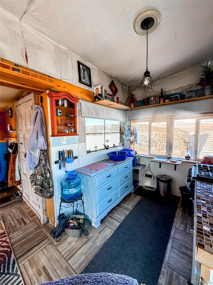 1725 35 1/10 Road De Beque, CO 81630 - Photo 19 of 36 a room with lots of furniture and a wooden floor