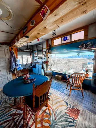 a living room with a table and chairs