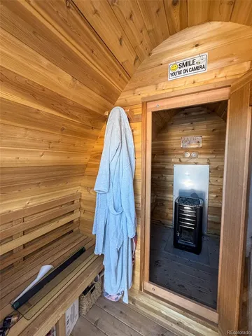 a view of a balcony with wooden floor and a bench