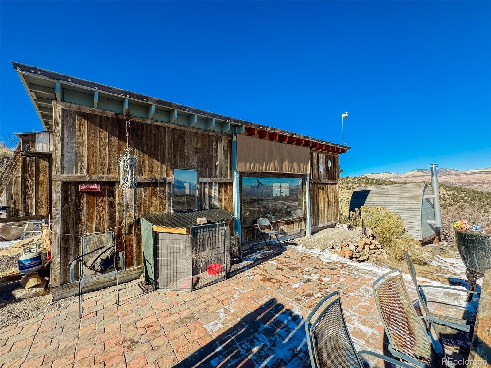1725 35 1/10 Road De Beque, CO 81630 - Photo 10 of 36 a bed sitting in a bedroom next to a chair