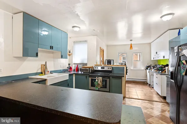 a kitchen with stainless steel appliances a sink stove and cabinets