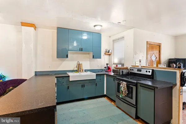 a kitchen with stainless steel appliances a stove refrigerator and microwave