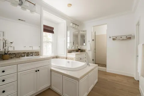 a spacious bathroom with a double vanity sink mirror and double