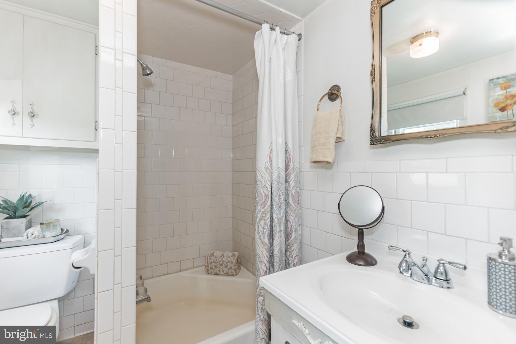 28814 Kemptown Road Damascus, MD 20872 - Photo 15 of 49 a bathroom with a sink and a mirror