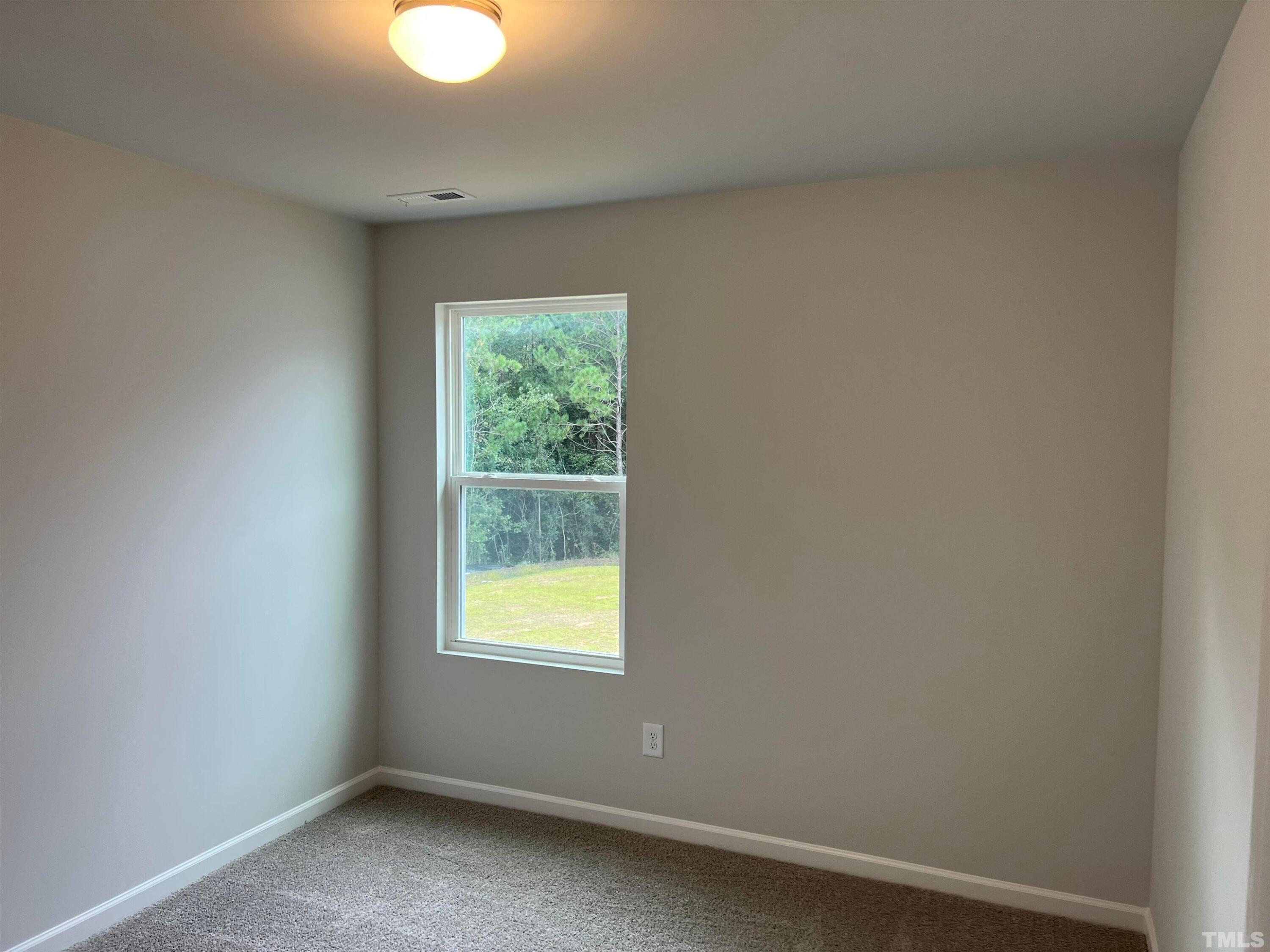 179 Maple Tree Lane Clayton, NC 27527 - Photo 16 of 18 a view of an empty room with a window