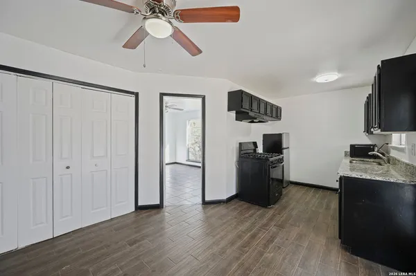 a kitchen with a refrigerator and a stove top oven