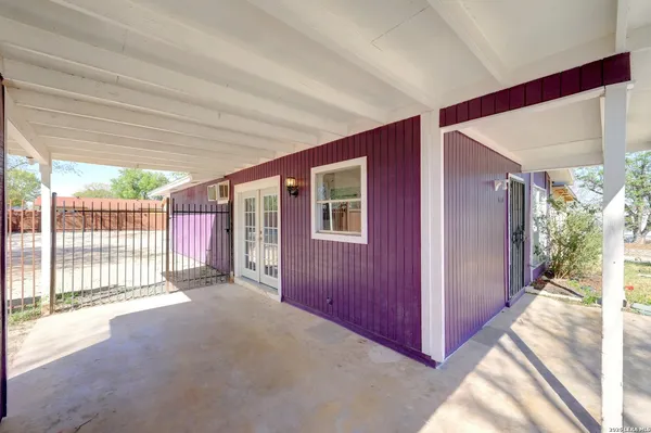 a view of a porch with wooden floor and fence