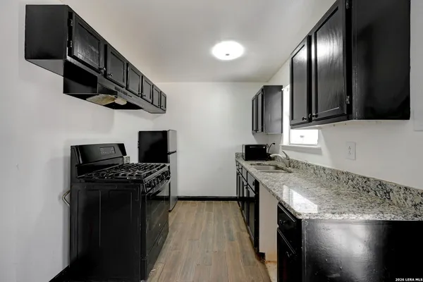 a kitchen with stainless steel appliances granite countertop a stove and a microwave