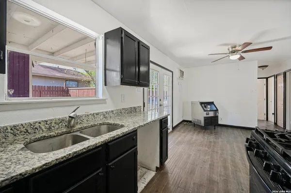 a kitchen with a sink stove and cabinets