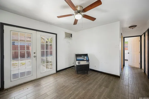 a view of empty room with wooden floor