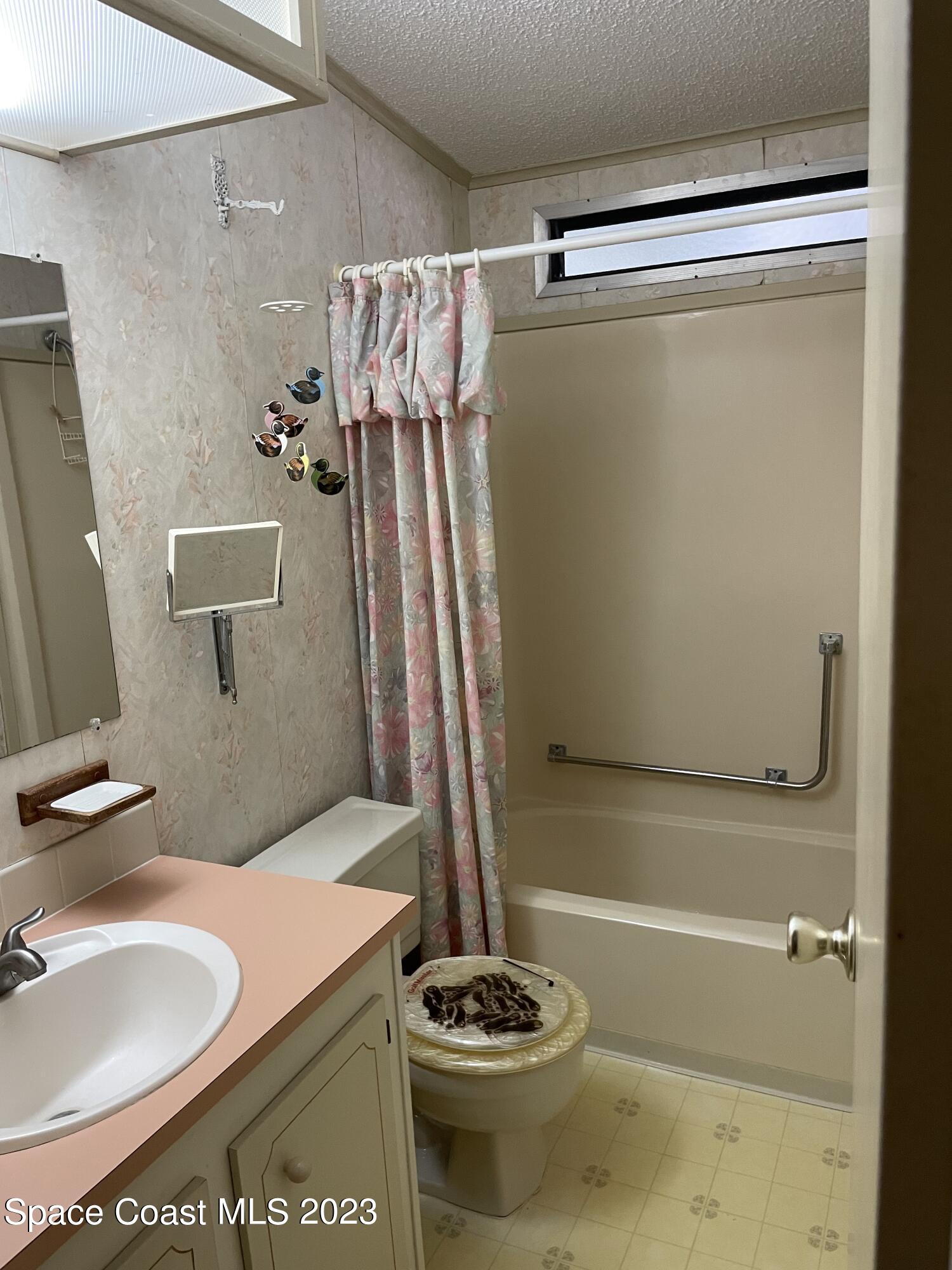 906 Oleander Circle Sebastian, FL 32976 - Photo 11 of 24 a bathroom with a shower and a sink
