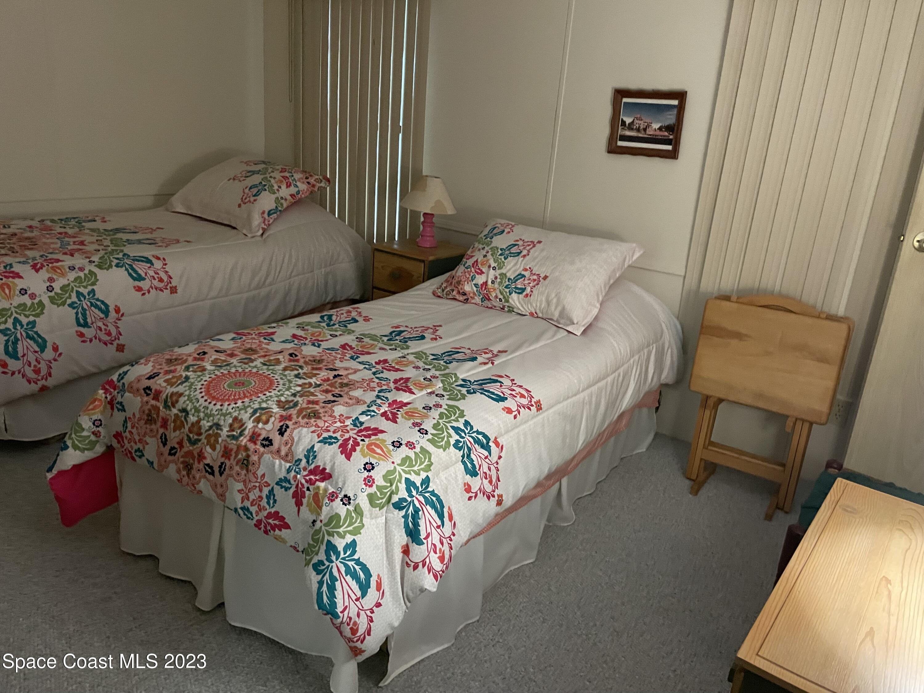 906 Oleander Circle Sebastian, FL 32976 - Photo 12 of 24 a bedroom with a bed bench and a window