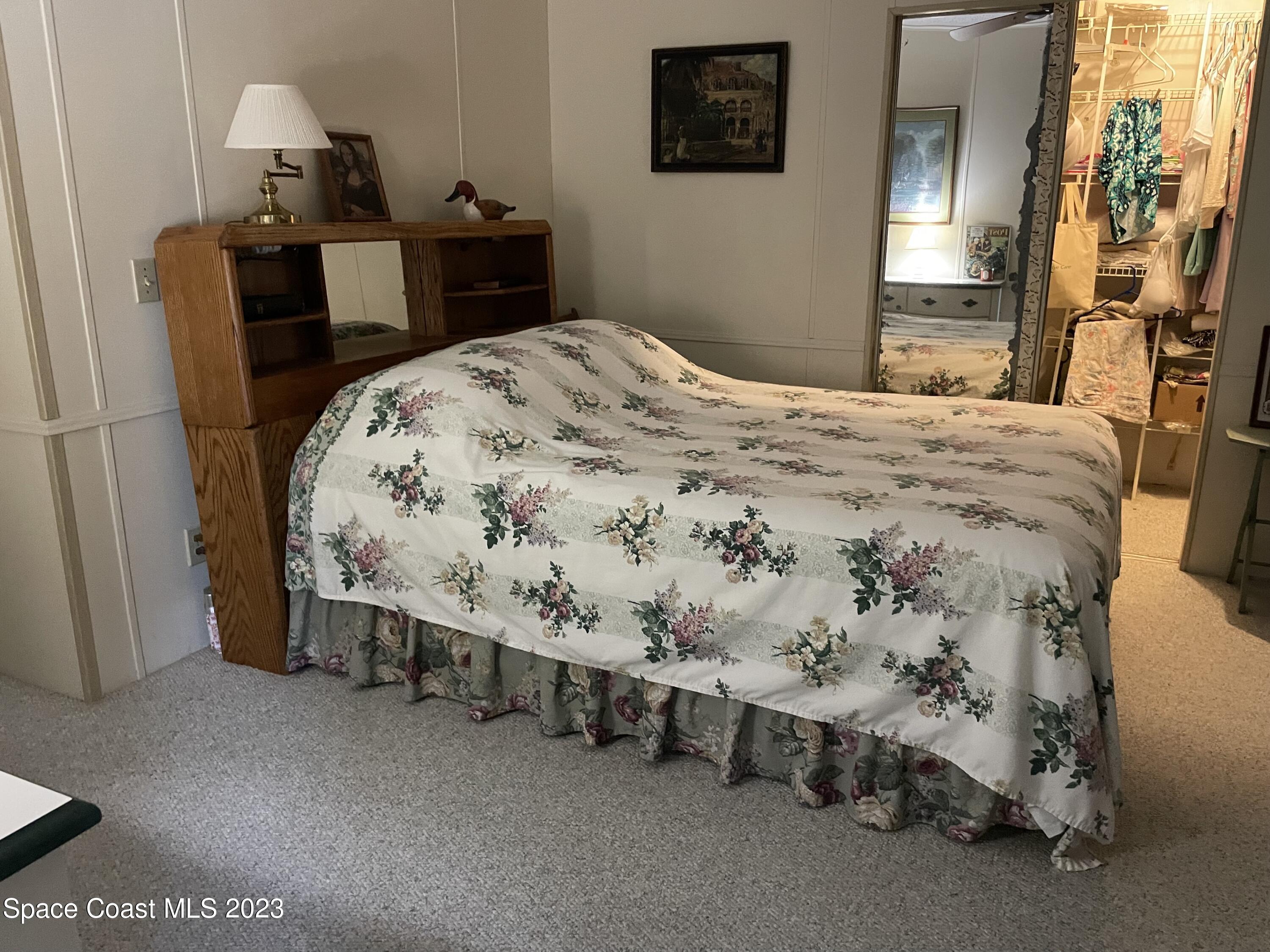 906 Oleander Circle Sebastian, FL 32976 - Photo 15 of 24 a bed sitting in a bedroom next to a window