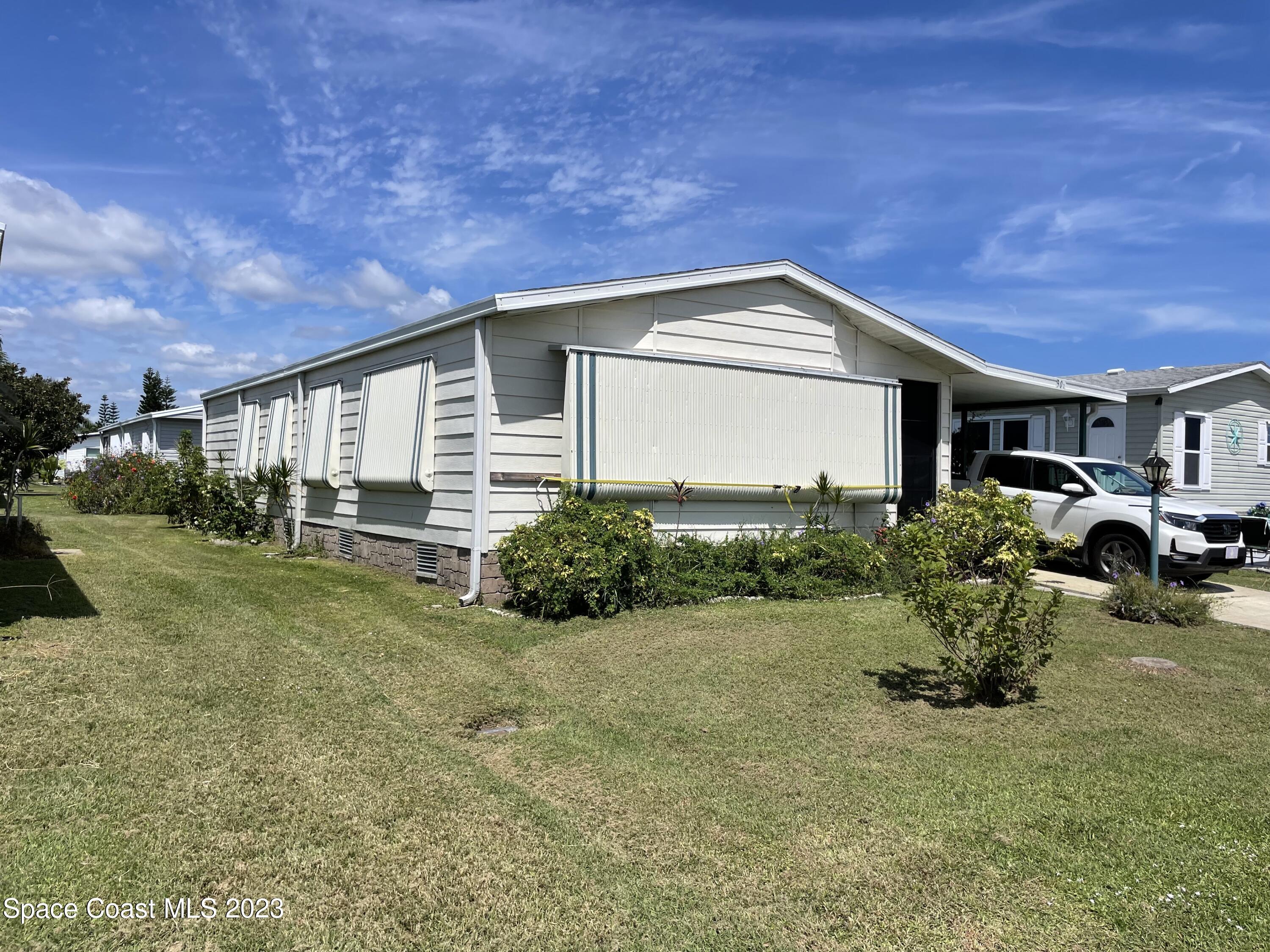 906 Oleander Circle Sebastian, FL 32976 - Photo 2 of 24 a front view of a house with garden