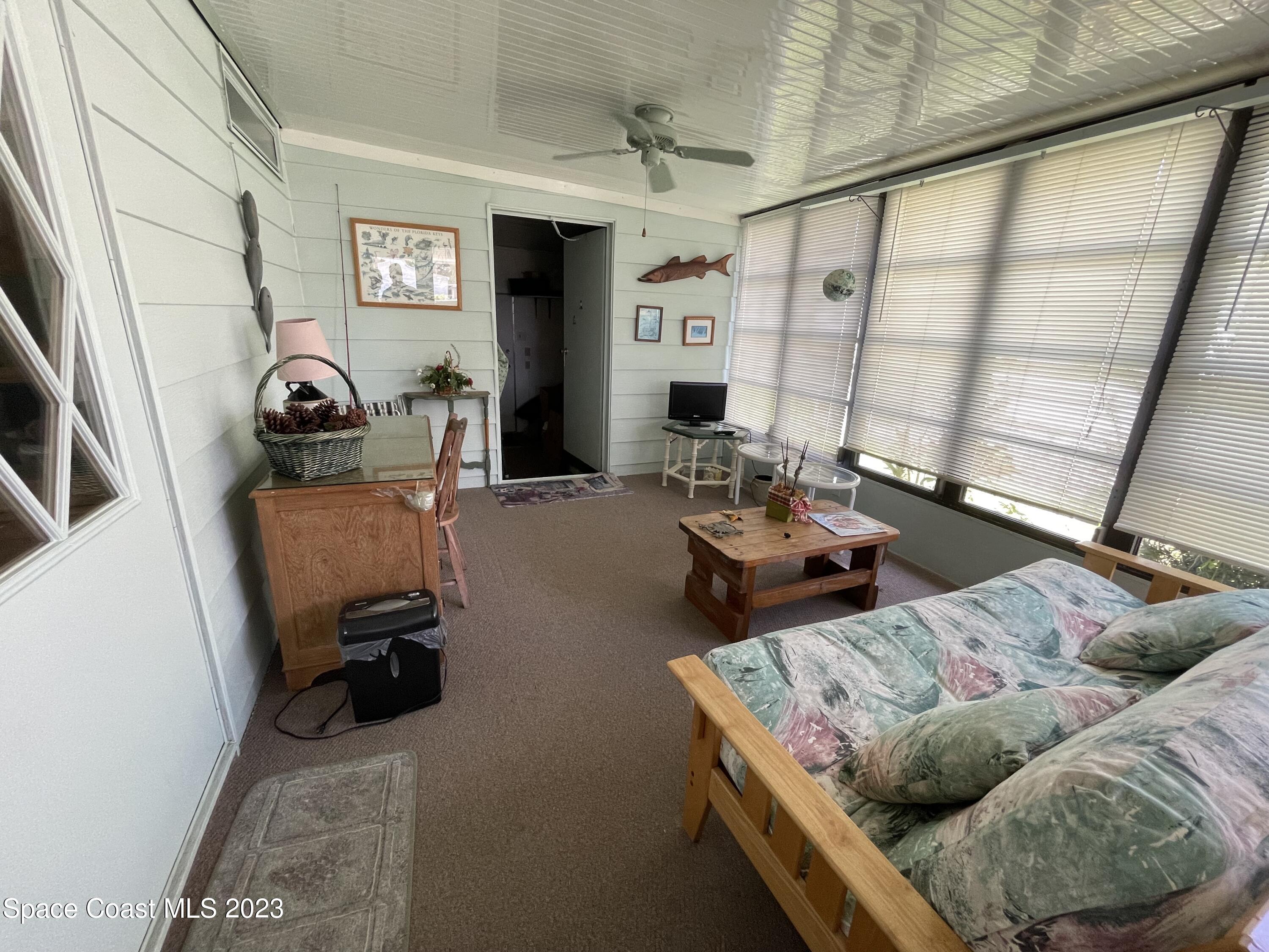 906 Oleander Circle Sebastian, FL 32976 - Photo 22 of 24 a living room with furniture and a window