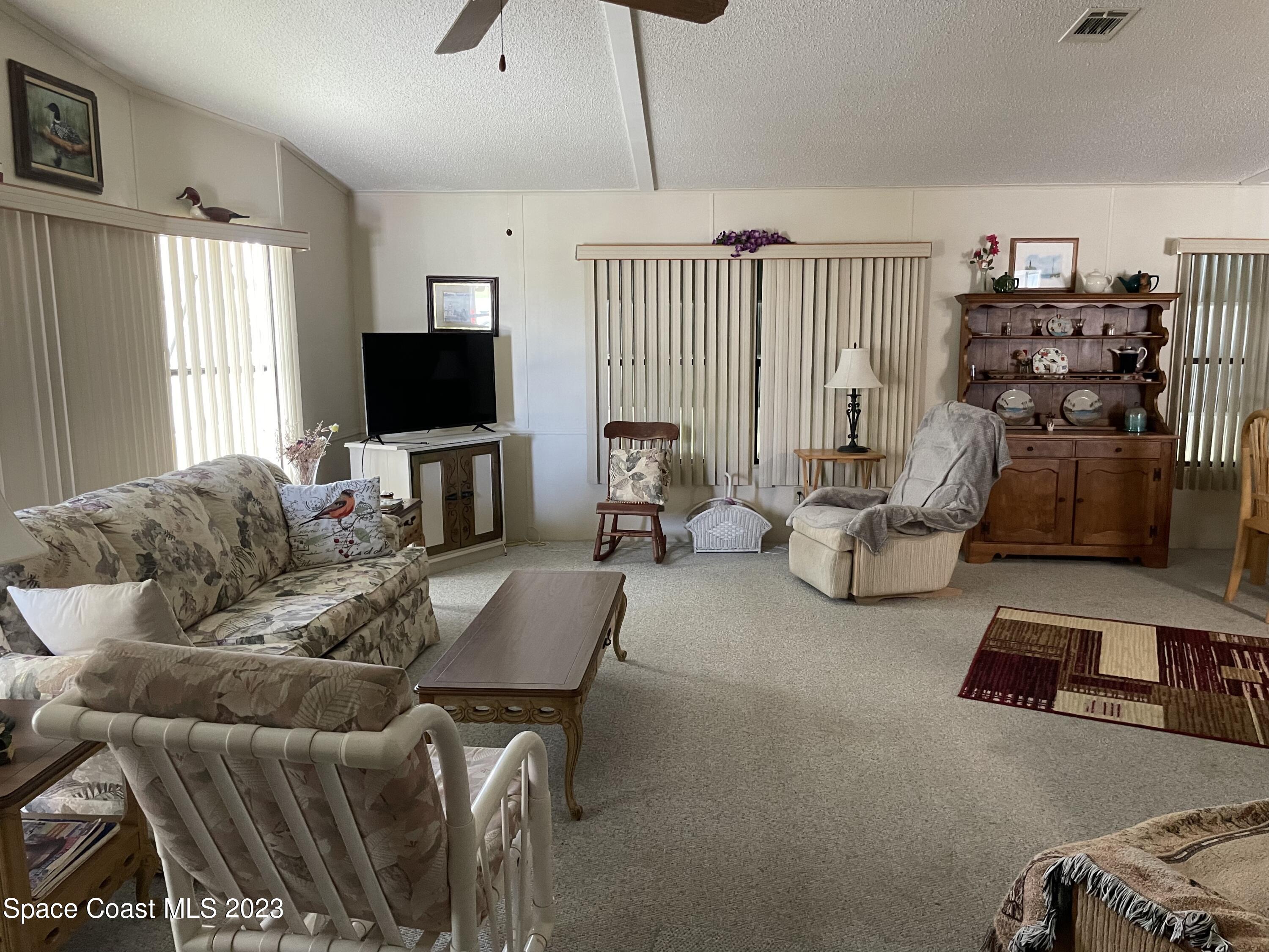 906 Oleander Circle Sebastian, FL 32976 - Photo 4 of 24 a living room with furniture and a flat screen tv