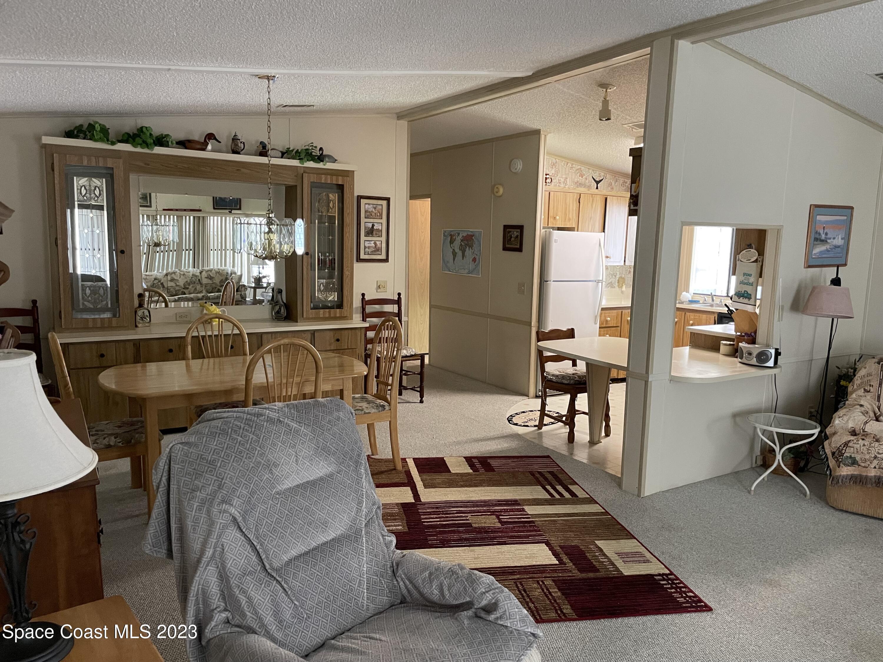 906 Oleander Circle Sebastian, FL 32976 - Photo 5 of 24 a room with furniture a chandelier and a dining table