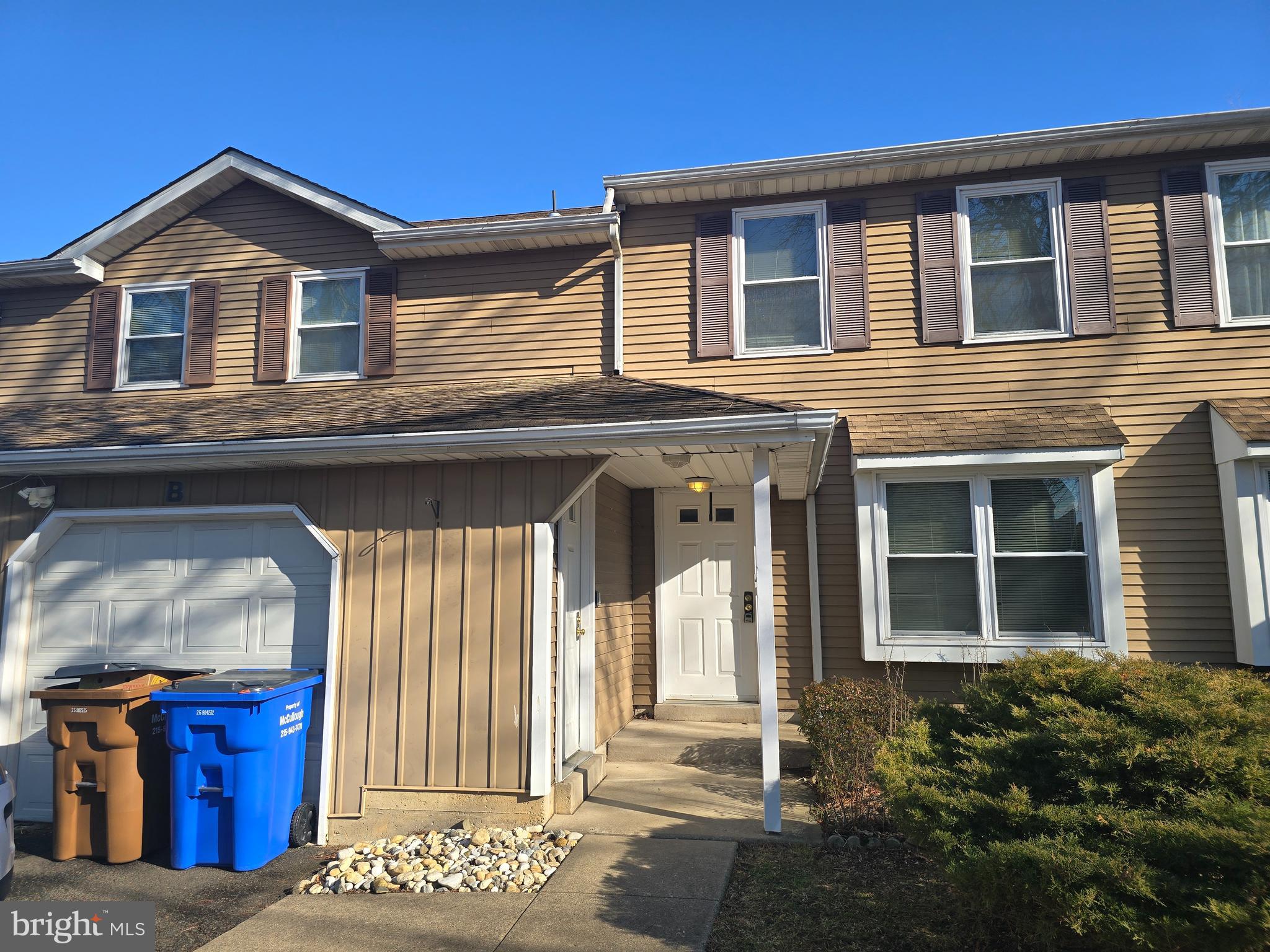 1769 North Dove Road, Unit A Yardley, PA 19067 - Photo 1 of 13 a front view of a house with a yard