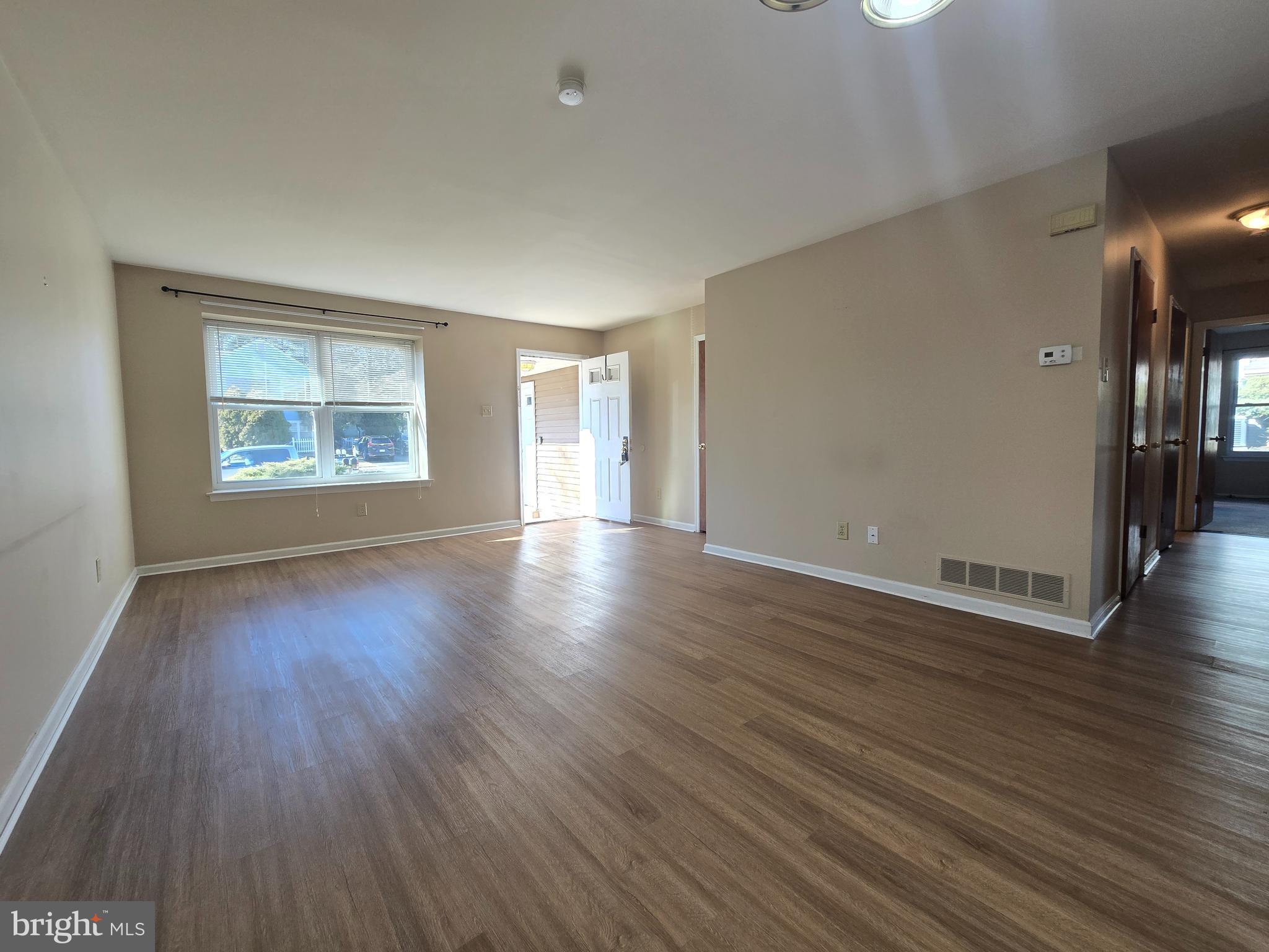 1769 North Dove Road, Unit A Yardley, PA 19067 - Photo 2 of 13 an empty room with wooden floor and windows