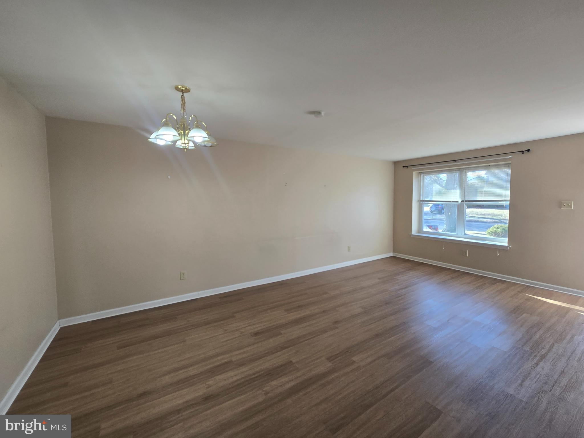 1769 North Dove Road, Unit A Yardley, PA 19067 - Photo 3 of 13 a view of an empty room with wooden floor and a window
