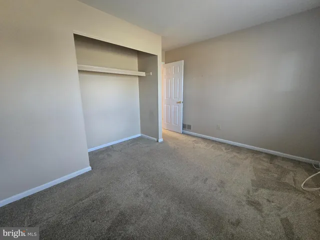 an empty room with closet area
