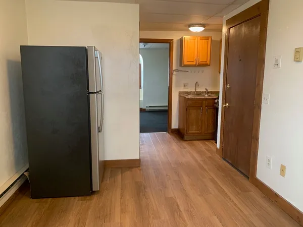 a view of a kitchen from a hallway