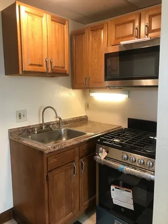 a kitchen with stainless steel appliances granite countertop a stove and a microwave