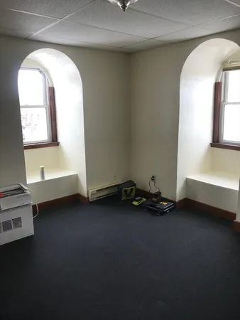 a view of a room with gym equipment and a window