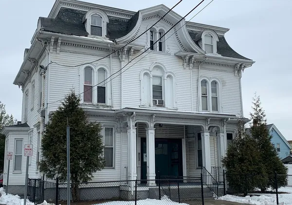 a front view of a house with plants