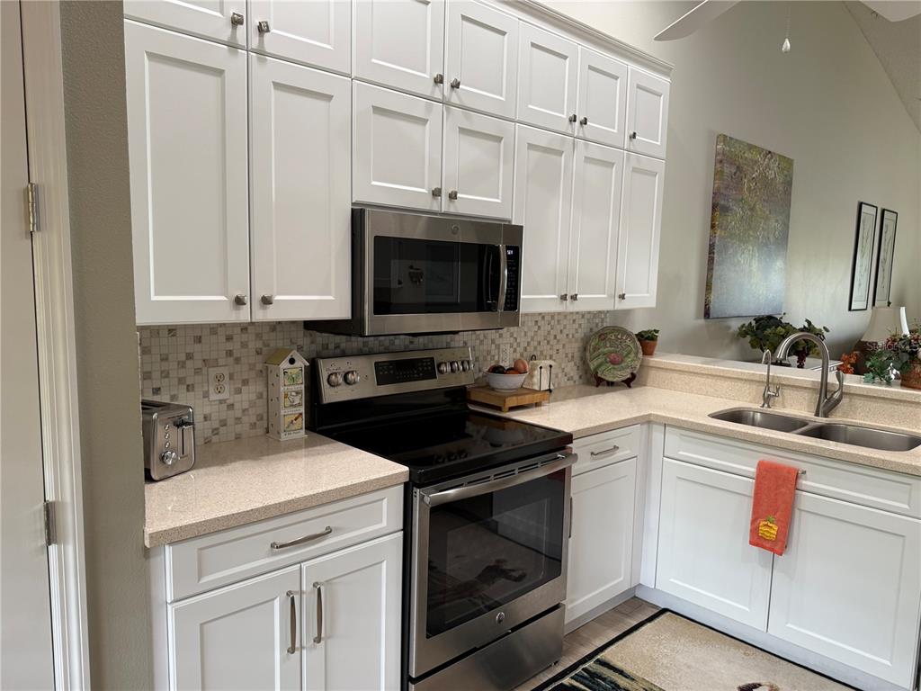 5251 Mahogany Run Avenue, Unit 524 Sarasota, FL 34241 - Photo 12 of 40 a kitchen with cabinets appliances a sink and a counter top space