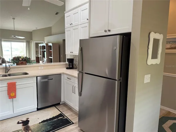 a kitchen with stainless steel appliances kitchen island granite countertop a sink a stove and cabinets
