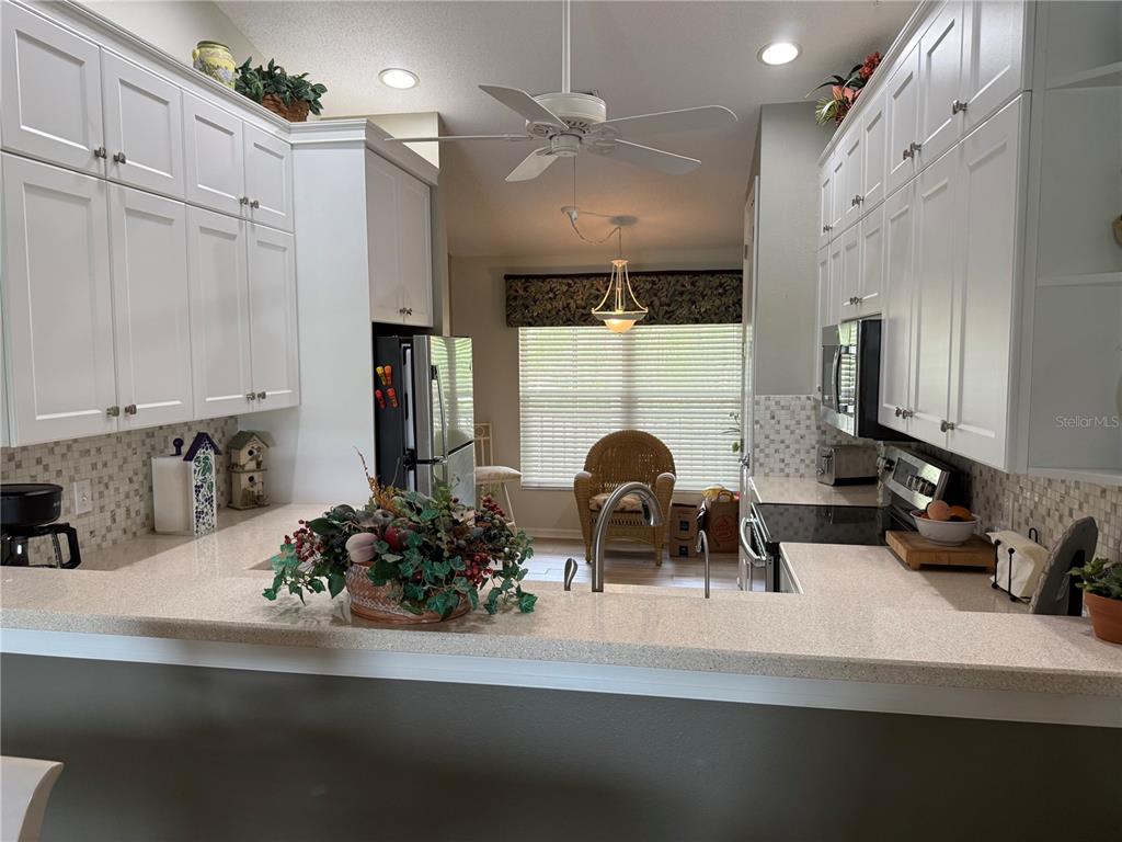 5251 Mahogany Run Avenue, Unit 524 Sarasota, FL 34241 - Photo 15 of 40 a kitchen with stainless steel appliances kitchen island granite countertop a sink a stove and cabinets