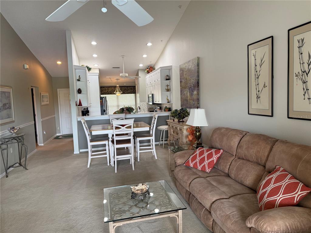 5251 Mahogany Run Avenue, Unit 524 Sarasota, FL 34241 - Photo 16 of 40 a living room with furniture wooden floor and a large window